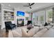 Cozy living room features a fireplace with built-in shelves, comfortable seating, and access to the outdoor space at 2340 Salt Wind Way, Mount Pleasant, SC 29466