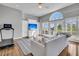 Bright living room with large windows, built-in entertainment center, hardwood floors, and a comfortable sofa at 2340 Salt Wind Way, Mount Pleasant, SC 29466