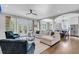 Spacious living room with comfortable seating, hardwood floors, and seamless transition to the kitchen and outdoor area at 2340 Salt Wind Way, Mount Pleasant, SC 29466