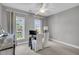 Well-lit office with views through bright windows, featuring a rustic desk and serene decor for a productive workspace at 2340 Salt Wind Way, Mount Pleasant, SC 29466