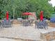 Great outdoor kitchen with stone fireplace and grill with seating and lush landscaping at 2340 Salt Wind Way, Mount Pleasant, SC 29466