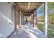 A covered patio features brick columns and a concrete floor, perfect for outdoor lounging at 2340 Salt Wind Way, Mount Pleasant, SC 29466