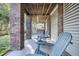 Underneath a home's patio with two chairs, brick columns, and a view of the wooded backyard at 2340 Salt Wind Way, Mount Pleasant, SC 29466
