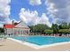 Stunning community pool and clubhouse with lounge chairs and umbrellas for residents at 2340 Salt Wind Way, Mount Pleasant, SC 29466