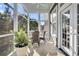 Serene screened porch with wicker chairs and a fern, perfect for relaxing outdoors at 2340 Salt Wind Way, Mount Pleasant, SC 29466