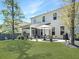 Spacious backyard with a green lawn and covered patio with outdoor furniture at 2823 Dearmin Dr, Mount Pleasant, SC 29466