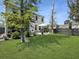 Wide shot of the backyard showing off the green grass, white house, and screened-in back porch at 2823 Dearmin Dr, Mount Pleasant, SC 29466