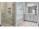 Bright bathroom featuring marble tile, glass enclosed shower, soaking tub, and ample vanity storage at 2823 Dearmin Dr, Mount Pleasant, SC 29466