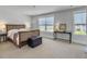 Comfortable bedroom with warm wood furniture, natural light from two windows, and neutral colored carpet at 2823 Dearmin Dr, Mount Pleasant, SC 29466