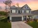 Two-story home featuring a neutral color scheme, shuttered windows, and a spacious two-car garage at 2823 Dearmin Dr, Mount Pleasant, SC 29466