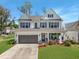 Charming two-story home with a well-manicured lawn, attached garage, and welcoming front porch at 2823 Dearmin Dr, Mount Pleasant, SC 29466