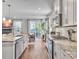 Open-concept kitchen features granite counters, stainless appliances, white cabinets, and an adjacent dining area at 2823 Dearmin Dr, Mount Pleasant, SC 29466