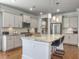 Bright kitchen features an island with seating, stainless steel appliances, white cabinets, and stylish pendant lighting at 2823 Dearmin Dr, Mount Pleasant, SC 29466