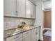 Detailed view of the kitchen with granite countertop, subway tile backsplash, and white cabinets at 2823 Dearmin Dr, Mount Pleasant, SC 29466