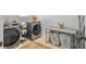 Well-equipped laundry room with side-by-side washer and dryer, folding table, and laundry accessories at 2823 Dearmin Dr, Mount Pleasant, SC 29466