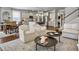 Open-concept living room with kitchen view, featuring neutral tones and wood floors at 2823 Dearmin Dr, Mount Pleasant, SC 29466