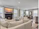 Bright living area featuring a fireplace, TV, hardwood floors, and modern decor at 2823 Dearmin Dr, Mount Pleasant, SC 29466