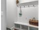 Organized mudroom with a built-in bench, cubbies, hooks, and a large wicker basket for storage at 2823 Dearmin Dr, Mount Pleasant, SC 29466