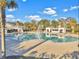 Large community pool with ample deck space, palm trees, and cabana-style structures at 2823 Dearmin Dr, Mount Pleasant, SC 29466