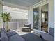 Relaxing covered porch with gray cushioned seating, an outdoor rug, and sliding glass doors to the home's interior at 2823 Dearmin Dr, Mount Pleasant, SC 29466