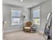 Cozy sitting area featuring two large windows and a wicker chair and stool at 2823 Dearmin Dr, Mount Pleasant, SC 29466