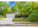 Well-kept single-story house featuring beautiful landscaping, mature trees, and a convenient two-car garage at 301 Huntington Ct, Hanahan, SC 29410