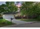 Charming single-story home with a well-maintained lawn, mature trees, and a two-car garage at 301 Huntington Ct, Hanahan, SC 29410