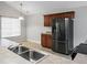 Kitchen with dark wood cabinets, modern stainless steel refrigerator, and neutral countertops at 301 Huntington Ct, Hanahan, SC 29410