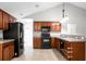 Kitchen with wood cabinets, black appliances, and sleek countertops at 301 Huntington Ct, Hanahan, SC 29410