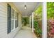 Covered porch with support columns, leading to the front door with black shutters accenting the siding at 301 Huntington Ct, Hanahan, SC 29410