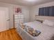 Cozy bedroom featuring hardwood floors, natural light, and a comfortable bed with a decorative blanket at 306 Fairlawn Drive, Moncks Corner, SC 29461