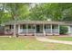 Charming single-story home with covered front porch and manicured lawn in a wooded neighborhood at 306 Fairlawn Drive, Moncks Corner, SC 29461