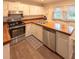 Functional kitchen featuring wood countertops, stainless steel appliances, and ample cabinet space at 306 Fairlawn Drive, Moncks Corner, SC 29461