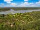 Aerial view of a large property with beautiful trees, surrounding landscape, and waterfront access at 3060 Bohicket Rd, Johns Island, SC 29455