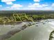 Expansive aerial view of the waterfront property highlighting its lush green landscape and docks at 3060 Bohicket Rd, Johns Island, SC 29455