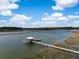 Picturesque aerial view showcasing a dock with a gazebo extending into the calm, clear waters at 3060 Bohicket Rd, Johns Island, SC 29455