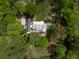 Aerial view of a luxury home surrounded by lush landscaping with a pool, garden, and large backyard at 3060 Bohicket Rd, Johns Island, SC 29455