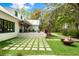 Beautiful backyard with a spacious patio, lush lawn, and a cozy fire pit area at 3060 Bohicket Rd, Johns Island, SC 29455