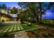 Backyard patio featuring an outdoor seating area, built-in fire pit, and lush green landscaping at 3060 Bohicket Rd, Johns Island, SC 29455