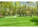 Spacious backyard with well manicured lawn, modern block retaining wall and pathways at 3060 Bohicket Rd, Johns Island, SC 29455