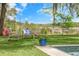 Inviting backyard seating area with a wicker bench and chairs offering serene views by the pool and water at 3060 Bohicket Rd, Johns Island, SC 29455