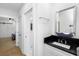 Modern bathroom vanity with black countertop and an adjacent doorway at 3060 Bohicket Rd, Johns Island, SC 29455