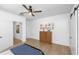 Bright bedroom with a ceiling fan, wood floors, white trim, and artwork at 3060 Bohicket Rd, Johns Island, SC 29455