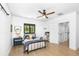 Spacious bedroom with a bed, ceiling fan, and natural light from the window at 3060 Bohicket Rd, Johns Island, SC 29455