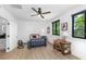 Well-lit bedroom featuring two windows, a ceiling fan, and a study desk at 3060 Bohicket Rd, Johns Island, SC 29455
