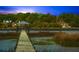 Picturesque dock stretches over serene waters to a charming gazebo under a twilight sky at 3060 Bohicket Rd, Johns Island, SC 29455