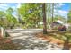 Spacious driveway with ample parking, surrounded by lush greenery and a well-maintained landscape at 3060 Bohicket Rd, Johns Island, SC 29455