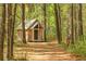 Charming wooden house nestled among mature trees and lush foliage at 3060 Bohicket Rd, Johns Island, SC 29455