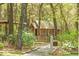 Charming wooden house nestled among mature trees and lush foliage at 3060 Bohicket Rd, Johns Island, SC 29455