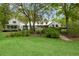 Stately two-story home with lush landscaping, well-maintained lawn and complementary trees at 3060 Bohicket Rd, Johns Island, SC 29455
